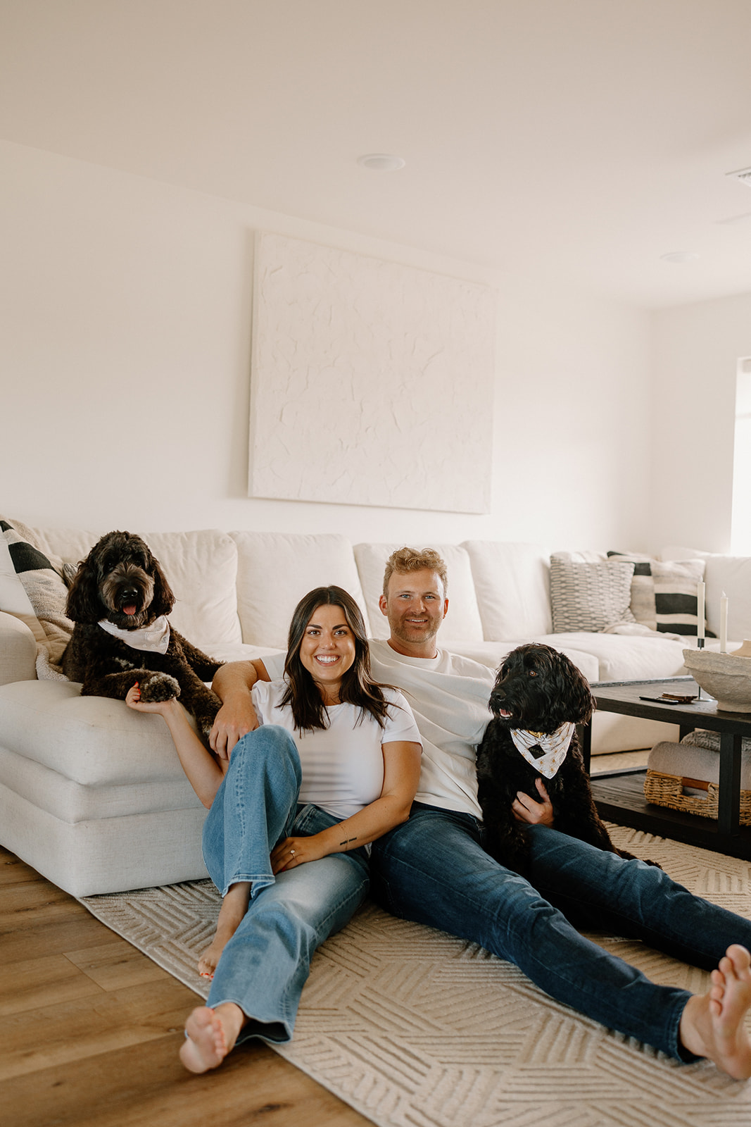 beautiful couple pose with their dogs during their in home engagement session