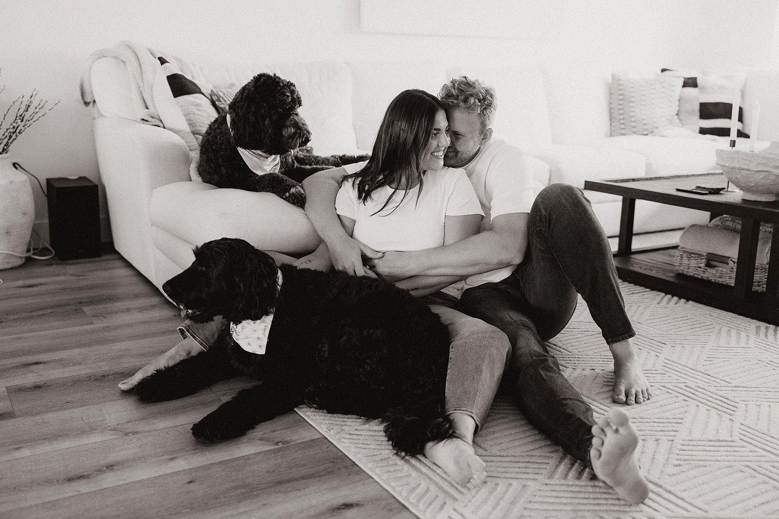 beautiful couple pose with their dogs during their in home engagement session