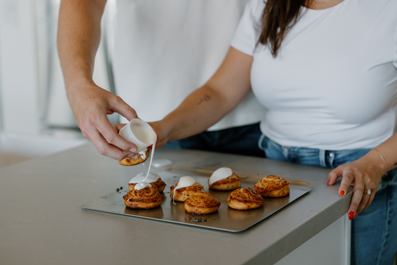 couple cooks together during their in home engagement photoshoot