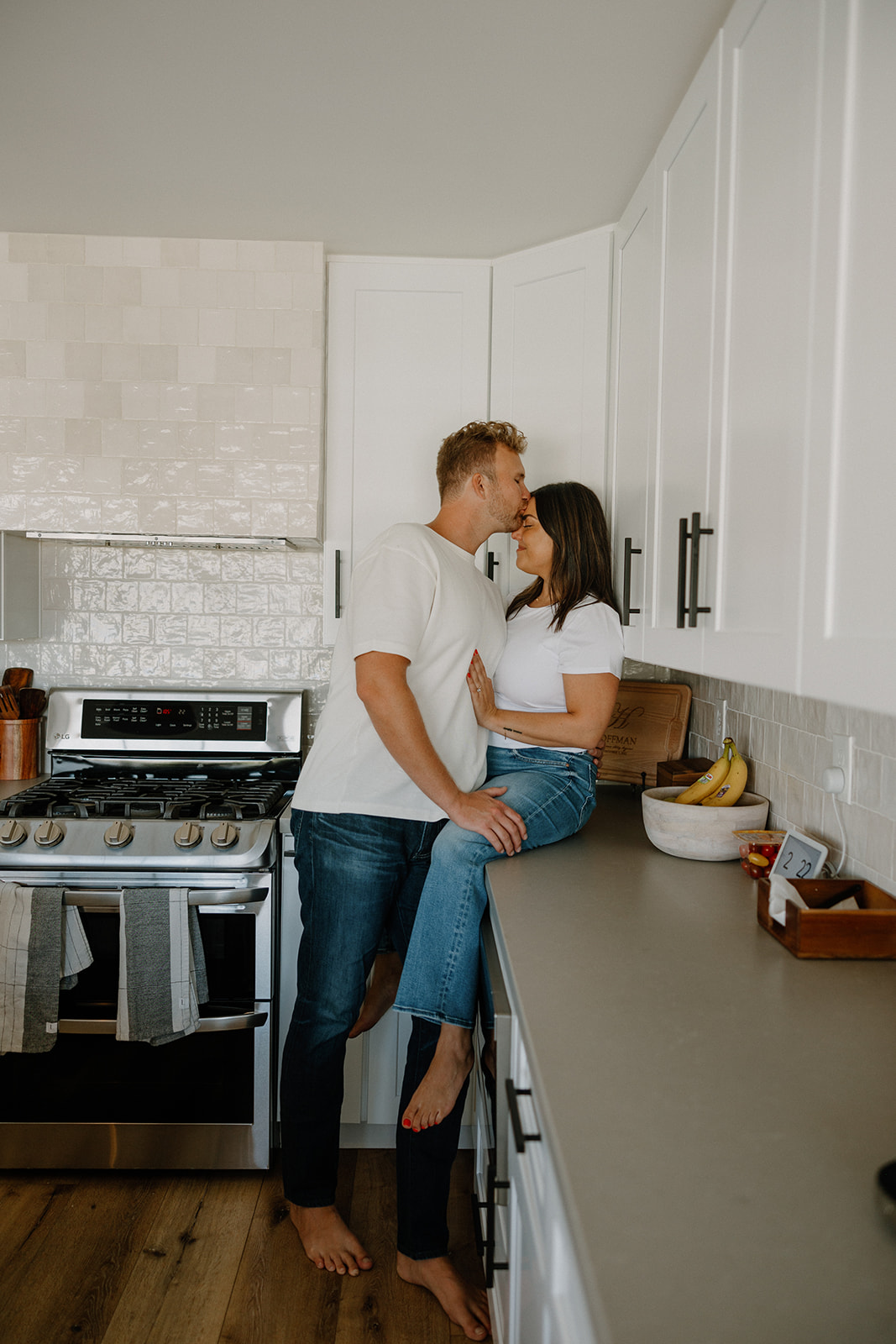 couple cooks together during their in home engagement photoshoot