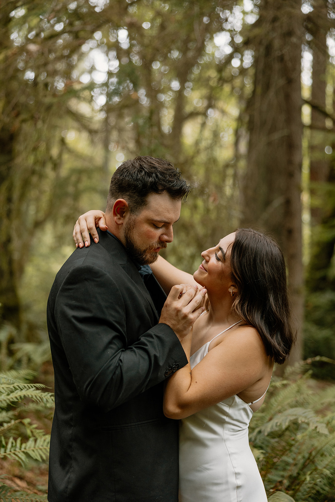 stunning couple pose in the PNW forest together during their wedding anniversary photoshoot with Kali M Photos!