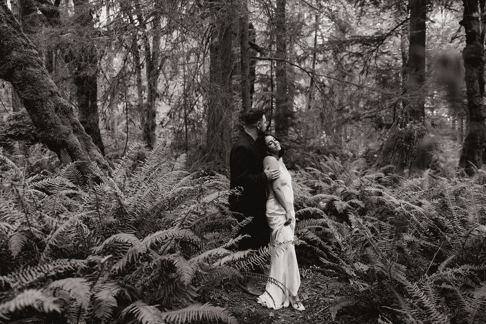 stunning couple pose in the PNW forest together during their wedding anniversary photoshoot with Kali M Photos!