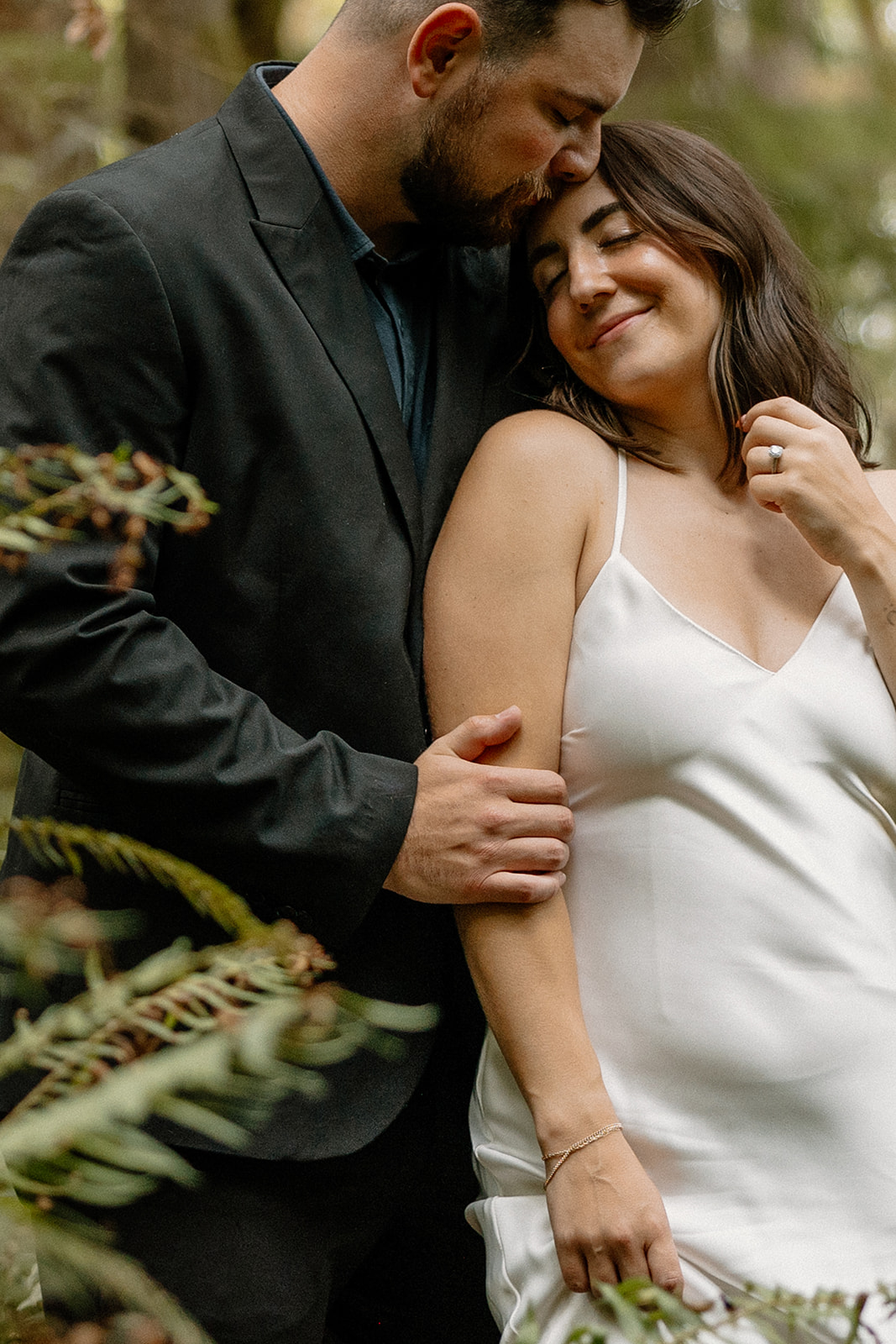 stunning couple pose in the PNW forest together