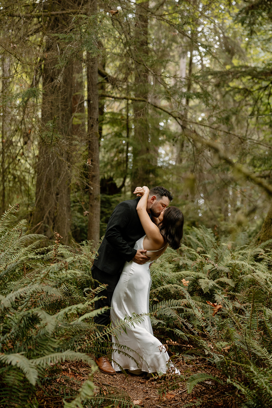 stunning couple pose in the PNW forest together 