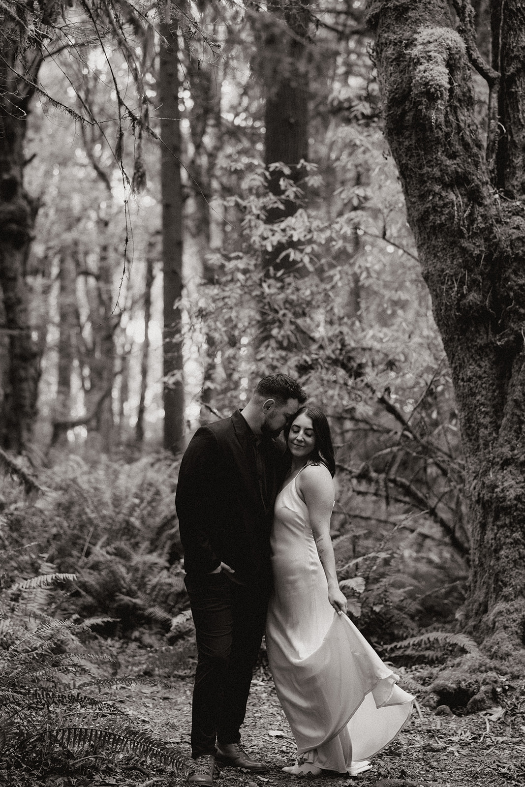 stunning couple pose in the PNW forest together during their wedding anniversary photoshoot with Kali M Photos!