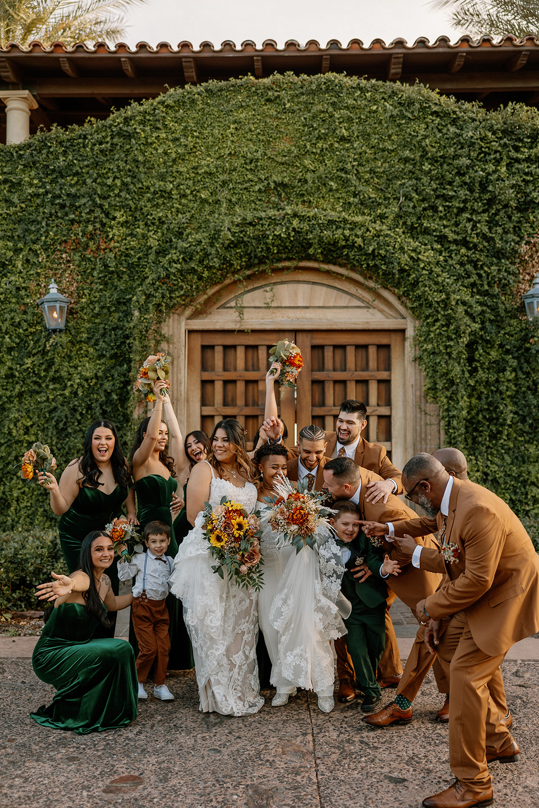 brides pose with their wedding party