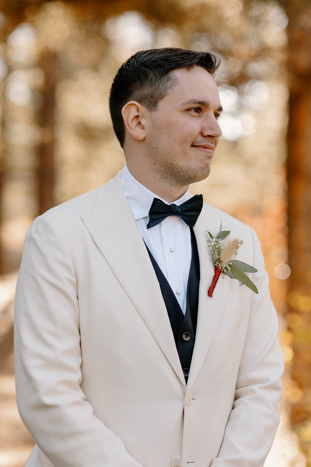 groom poses in the Arizona nature