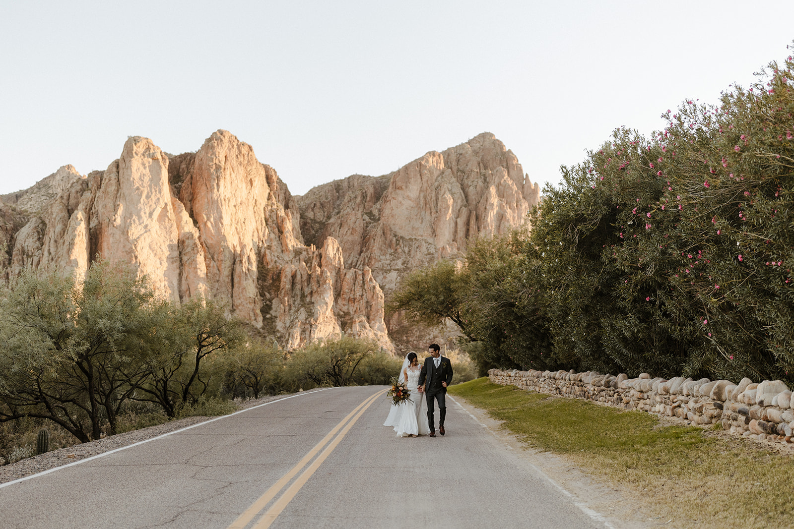 couple walk in the road during Arizona photoshoot