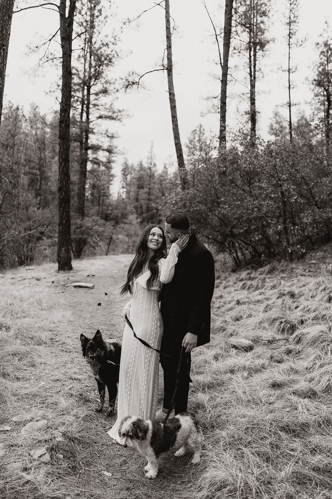 beautiful couple pose together in the forest