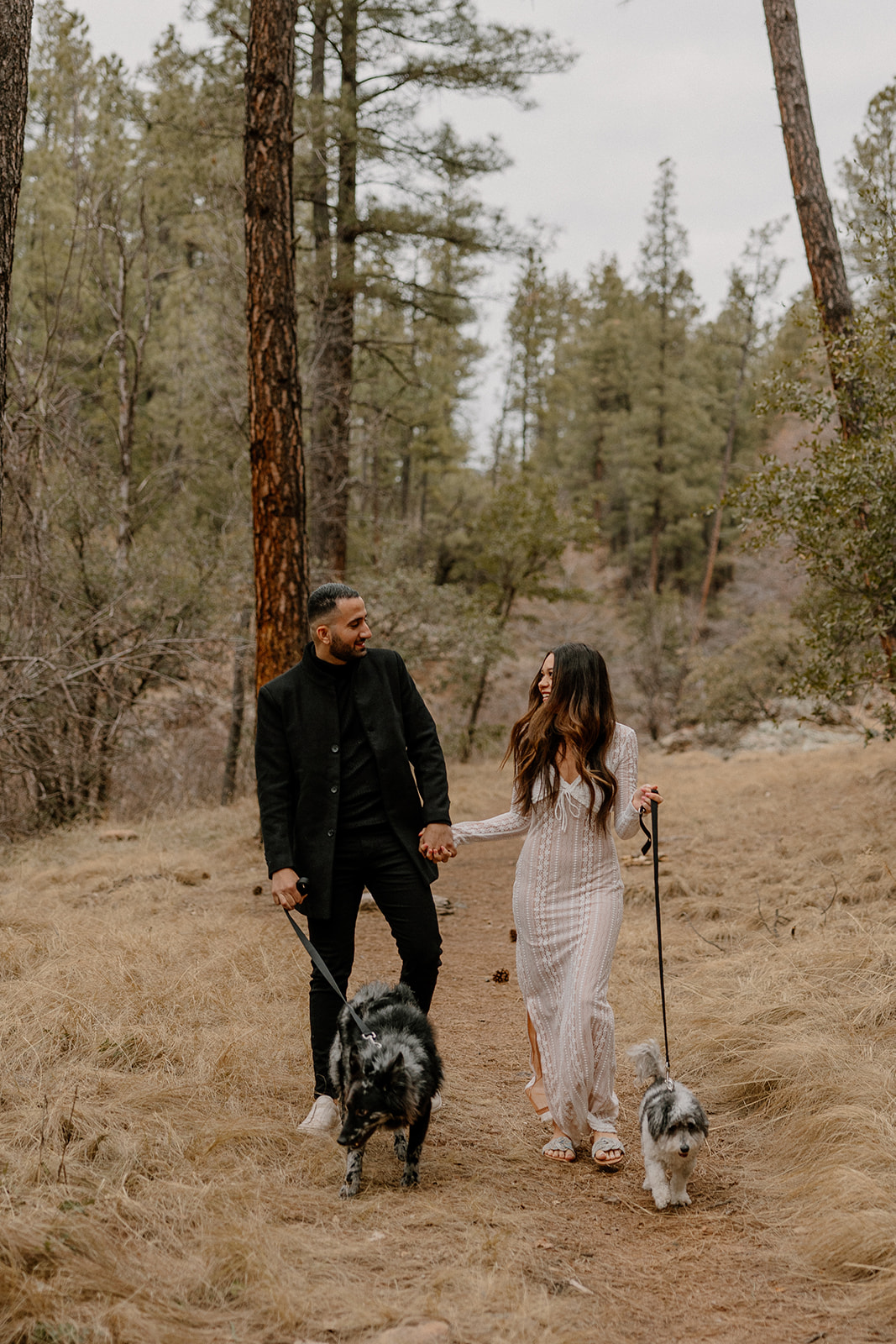 beautiful couple pose together in the forest