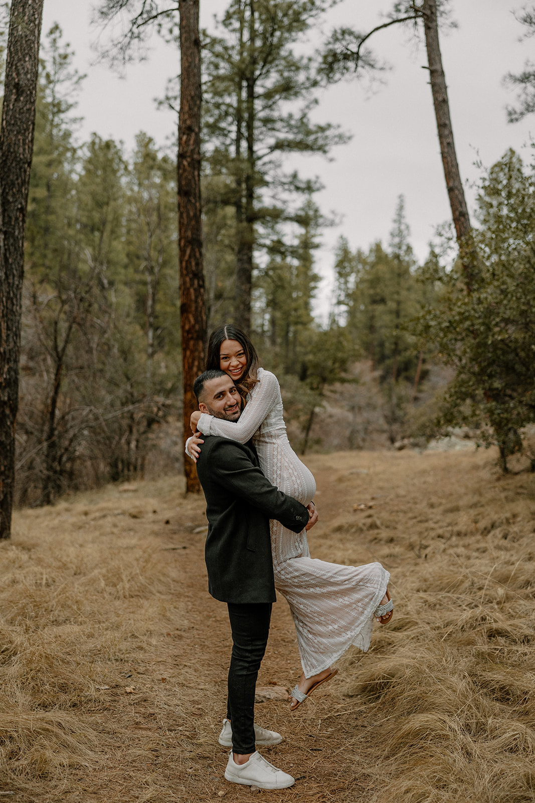 beautiful couple pose together in the forest