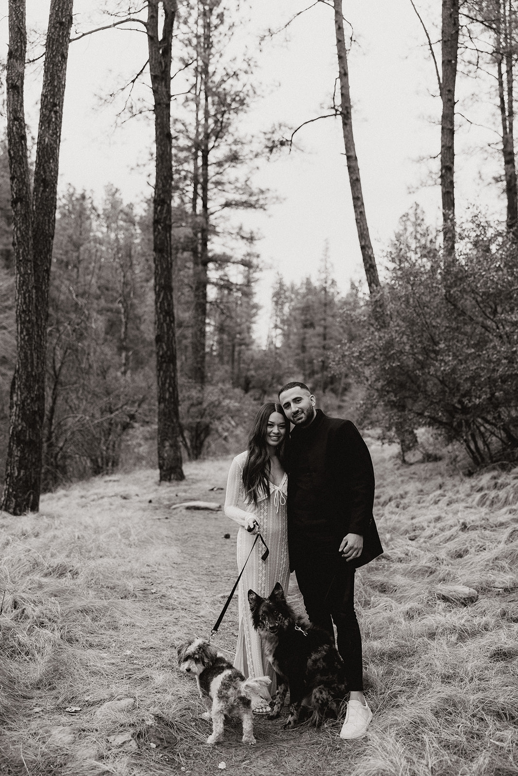 beautiful couple pose together in the forest