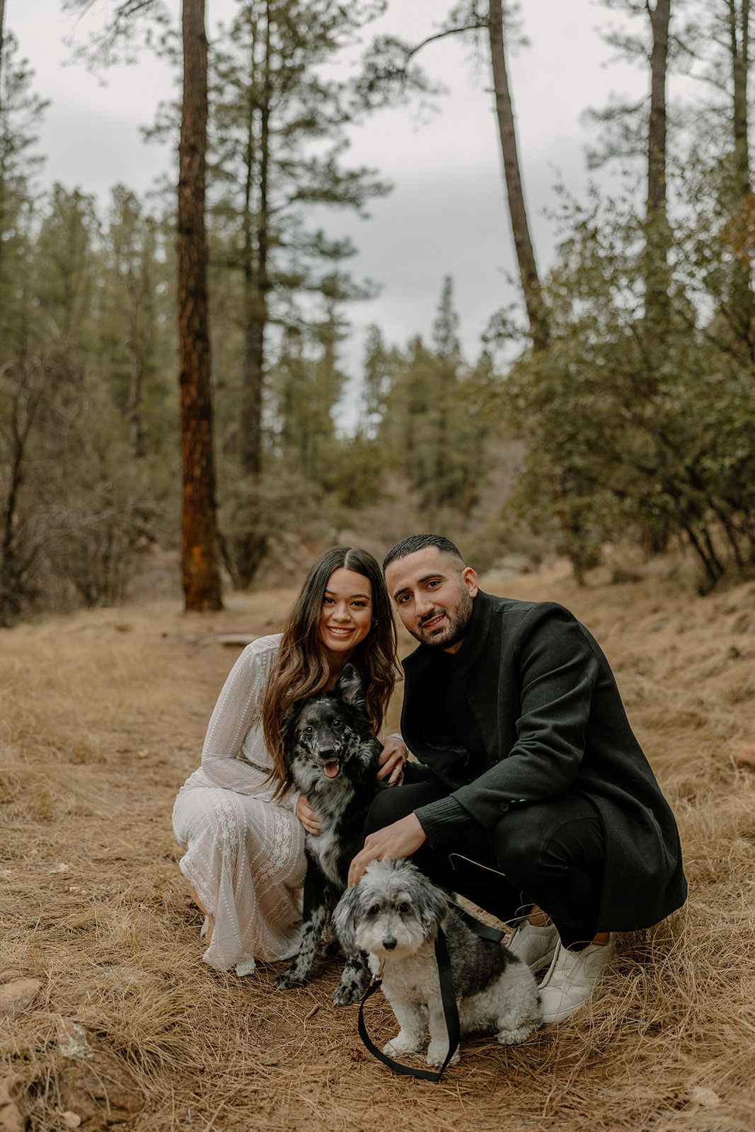 beautiful couple pose together in the forest