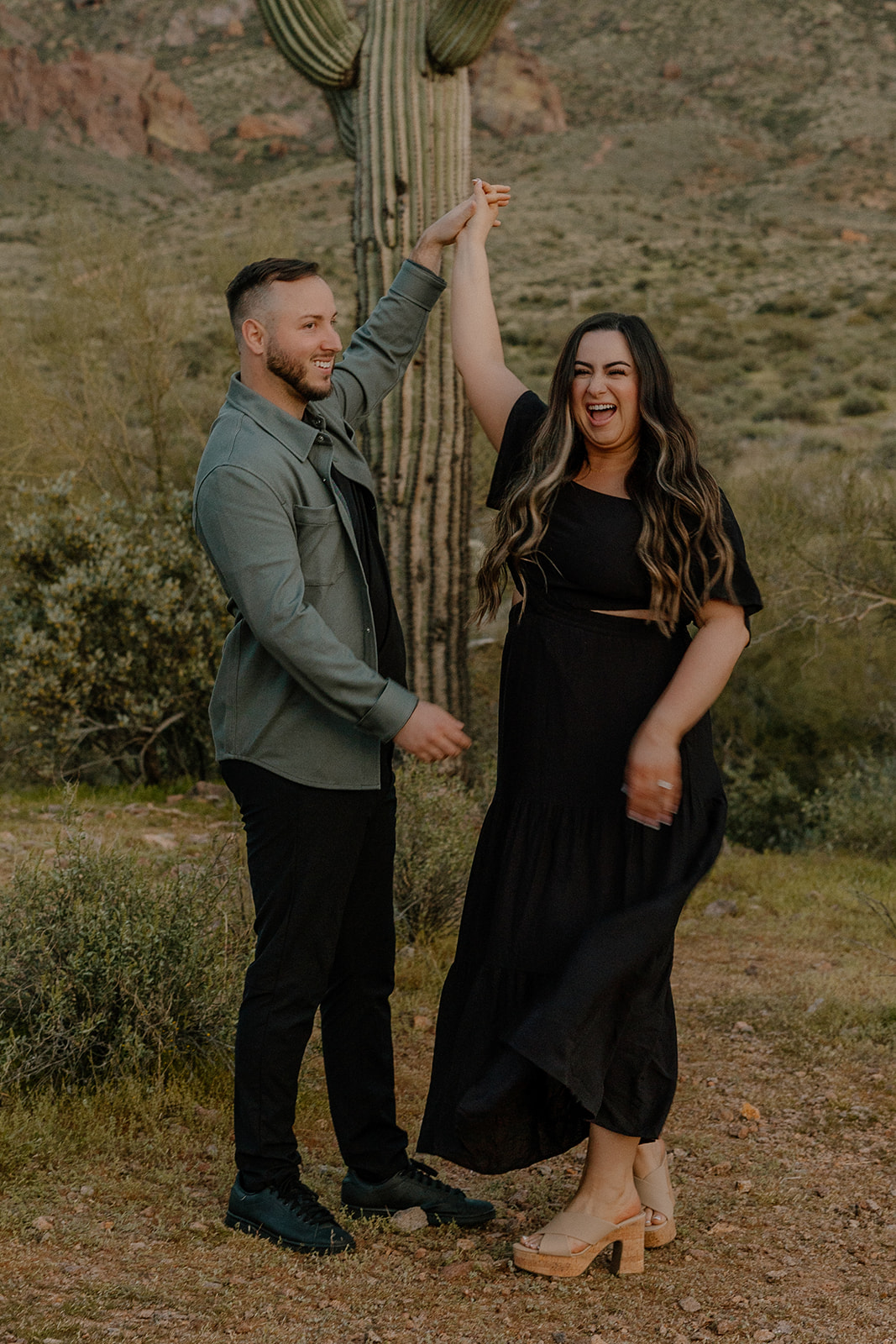 beautiful couple pose in the Arizona desert their engagement photoshoot