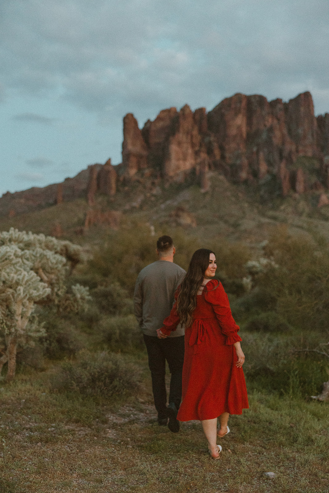 couple pose together in front of an Arizona mountain range