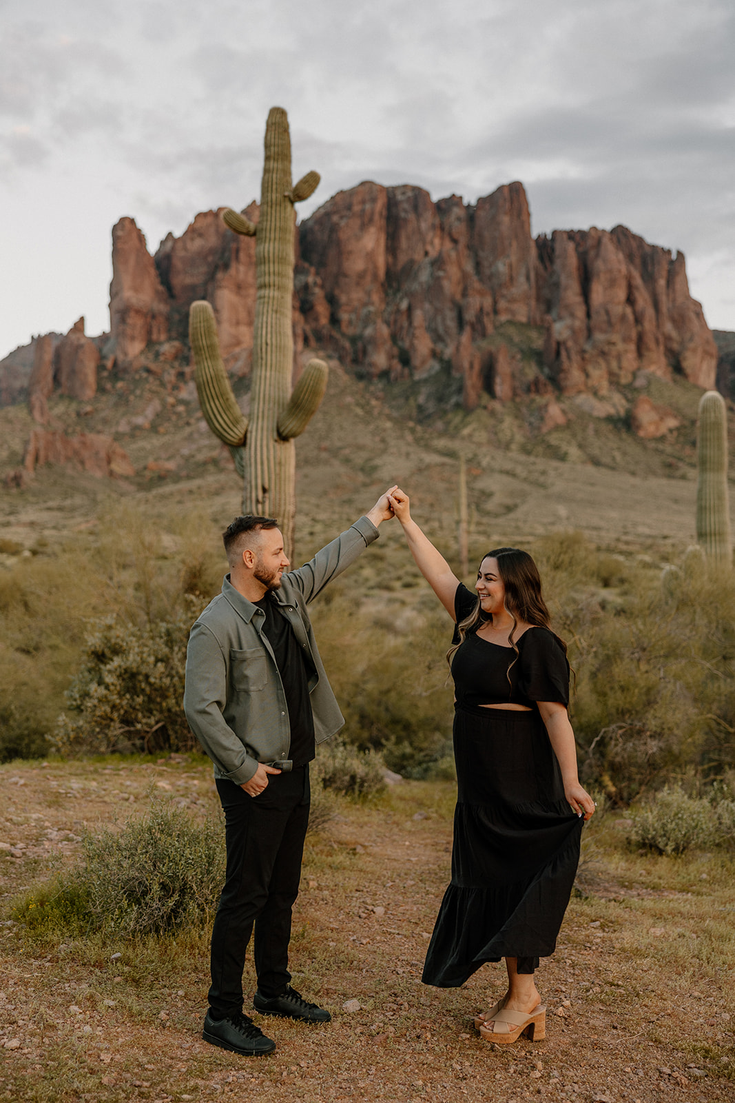 beautiful couple pose in the Arizona desert their engagement photoshoot