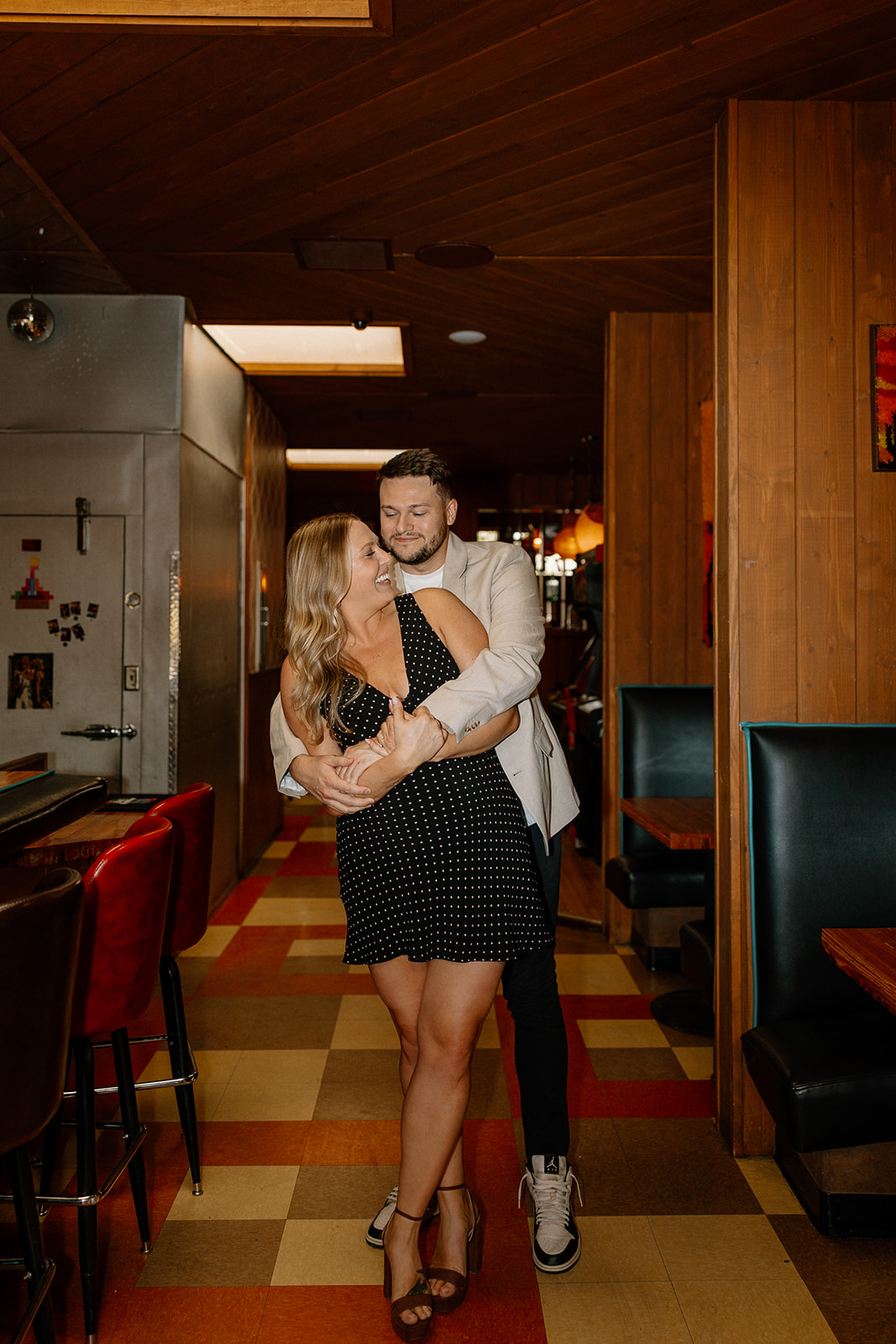 gorgeous couple takes their engagement photoshoot indoors to their favorite bar