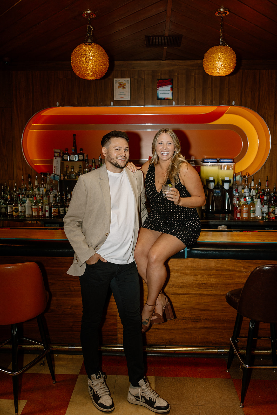 gorgeous couple takes their engagement photoshoot indoors to their favorite bar