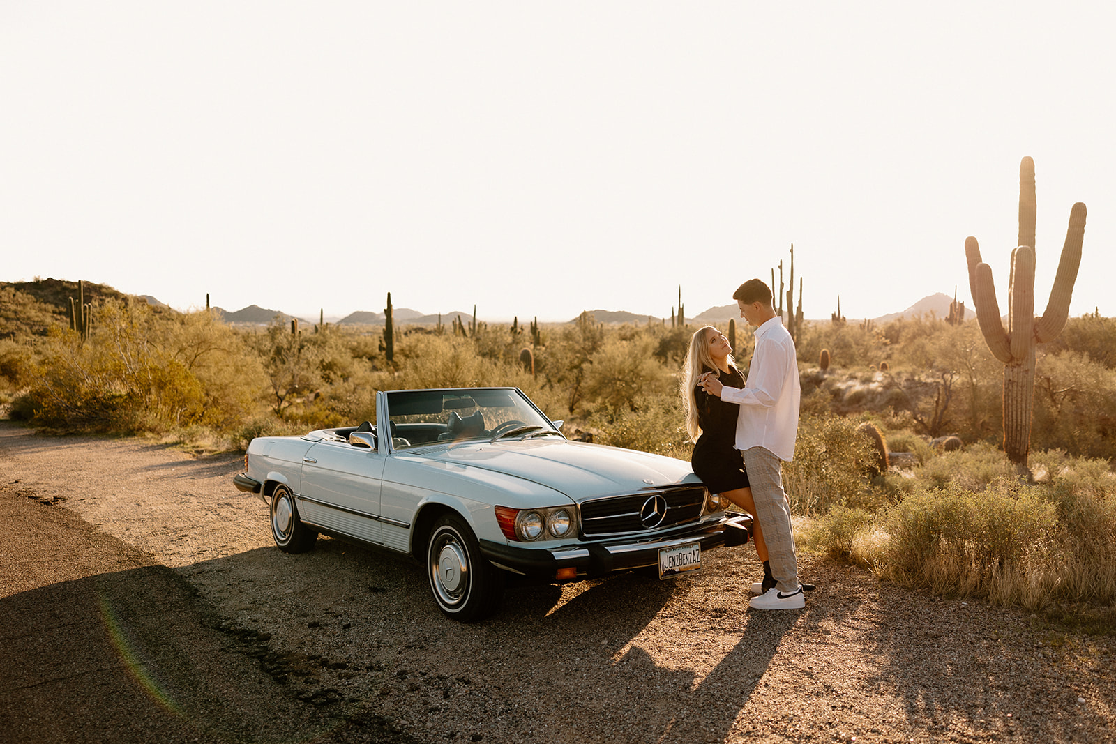 beautiful couple pose with a vintage car in the Arizona desert