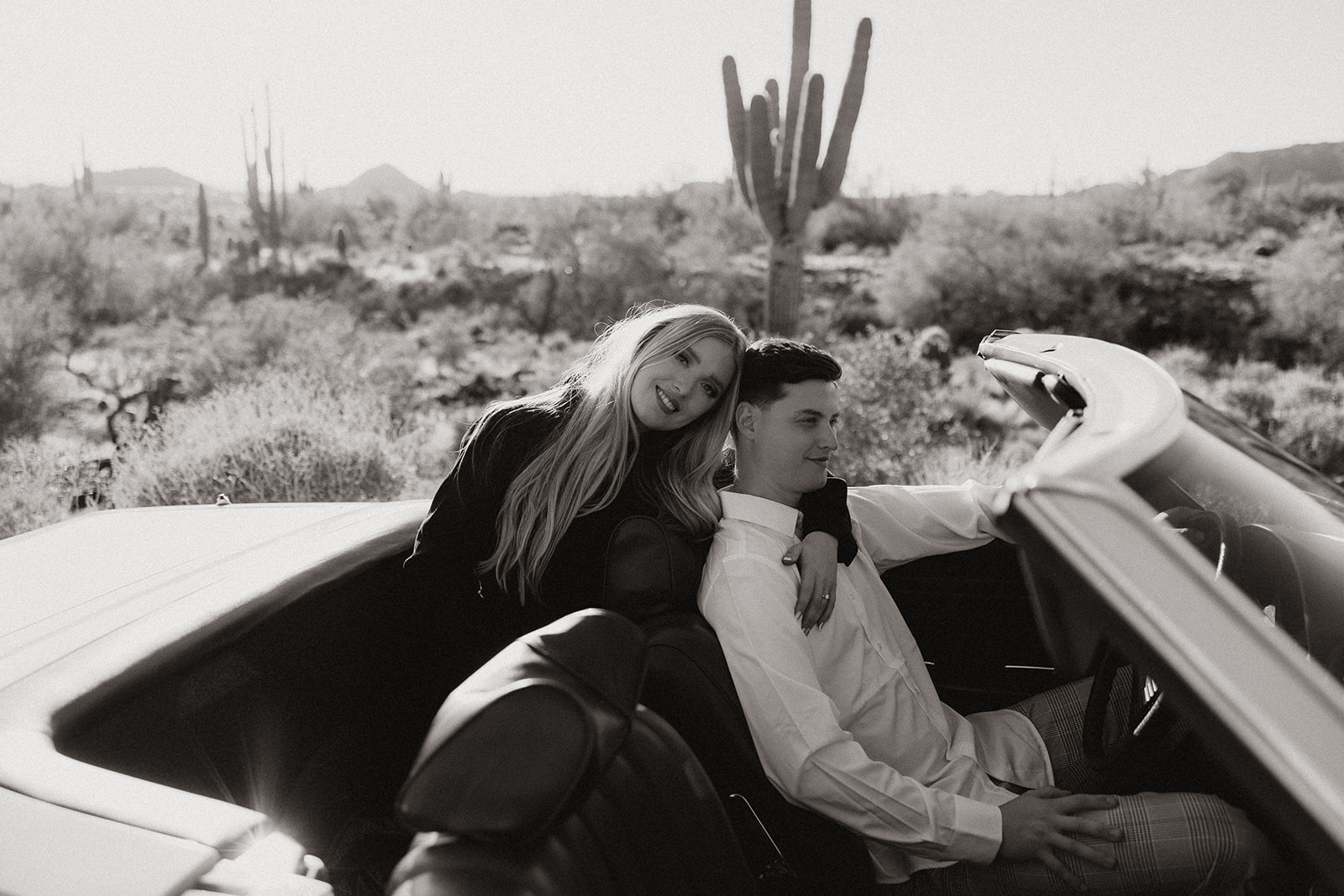 beautiful couple pose with a vintage car in the Arizona desert