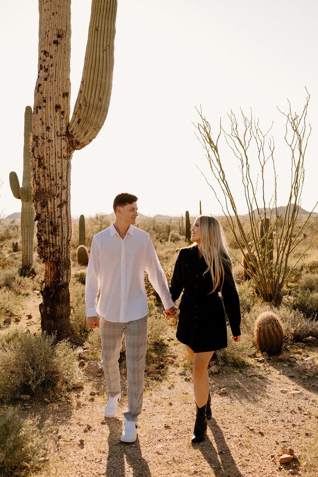 beautiful couple pose in the Arizona desert their engagement photoshoot