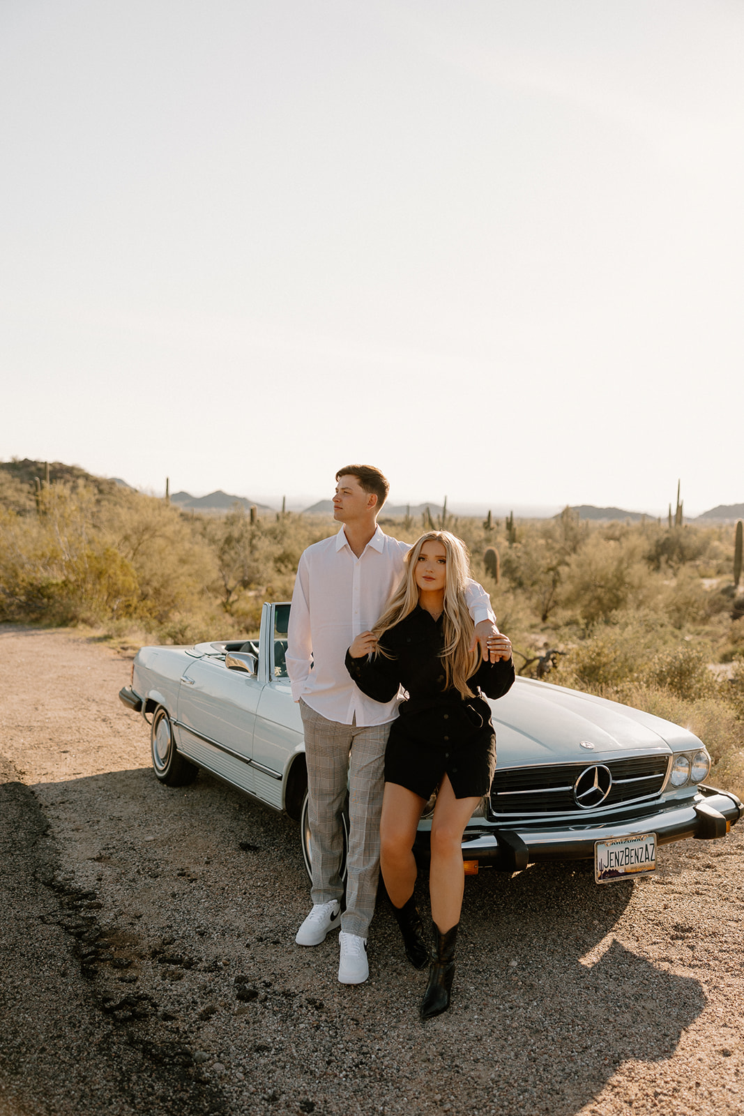 beautiful couple pose with a vintage car in the Arizona desert