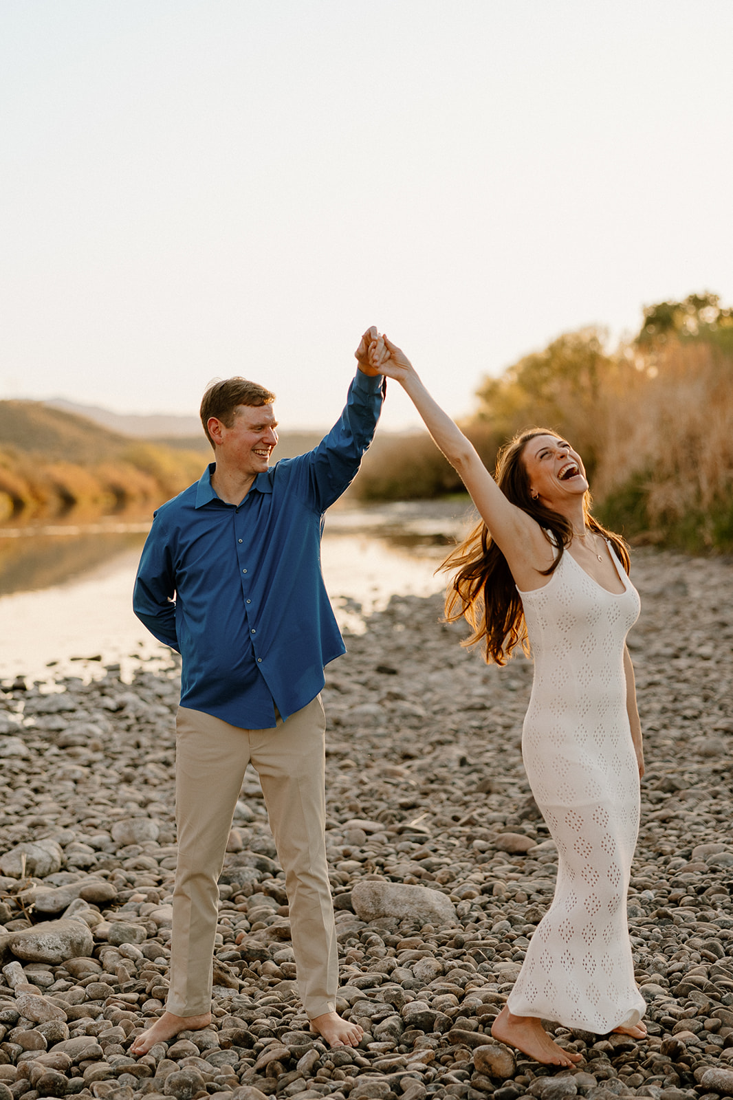 couple share intimate moments by the water during their Arizona engagement photoshoot