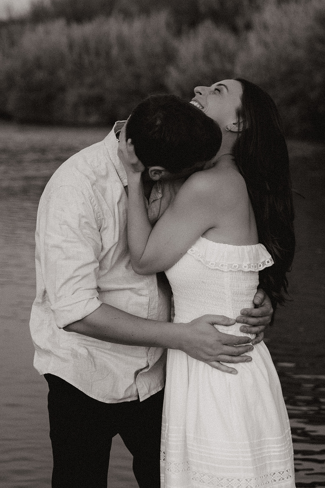 couple share intimate moments by the water during their Arizona engagement photoshoot