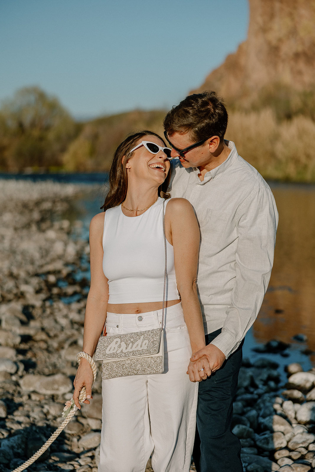 couple share intimate moments by the water during their Arizona engagement photoshoot