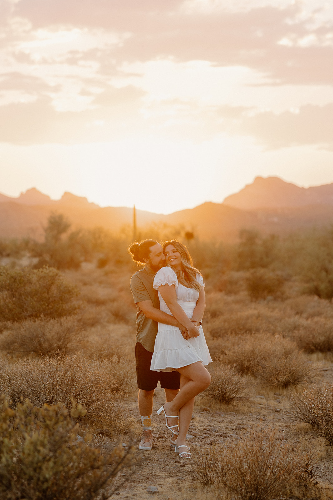 beautiful couple pose in the Arizona desert their engagement photoshoot