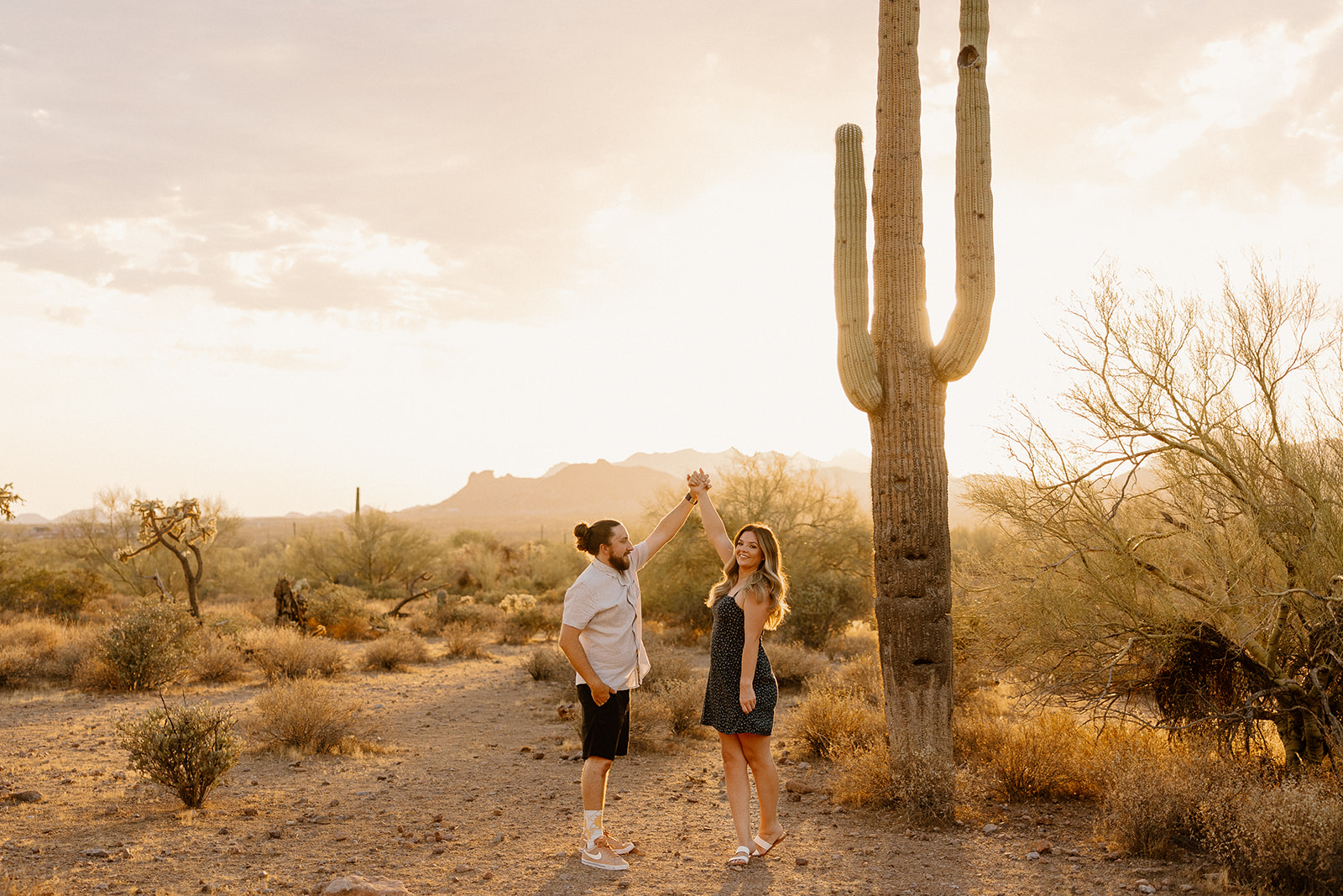 beautiful couple pose in the Arizona desert their engagement photoshoot