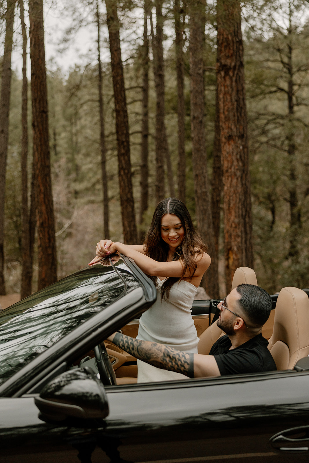 beautiful couple pose with their luxury car during their engagement photoshoot