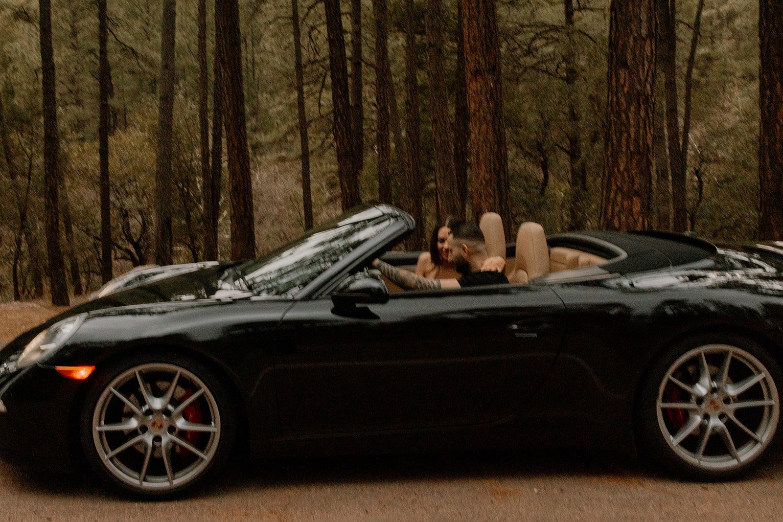 beautiful couple pose with their luxury car during their engagement photoshoot