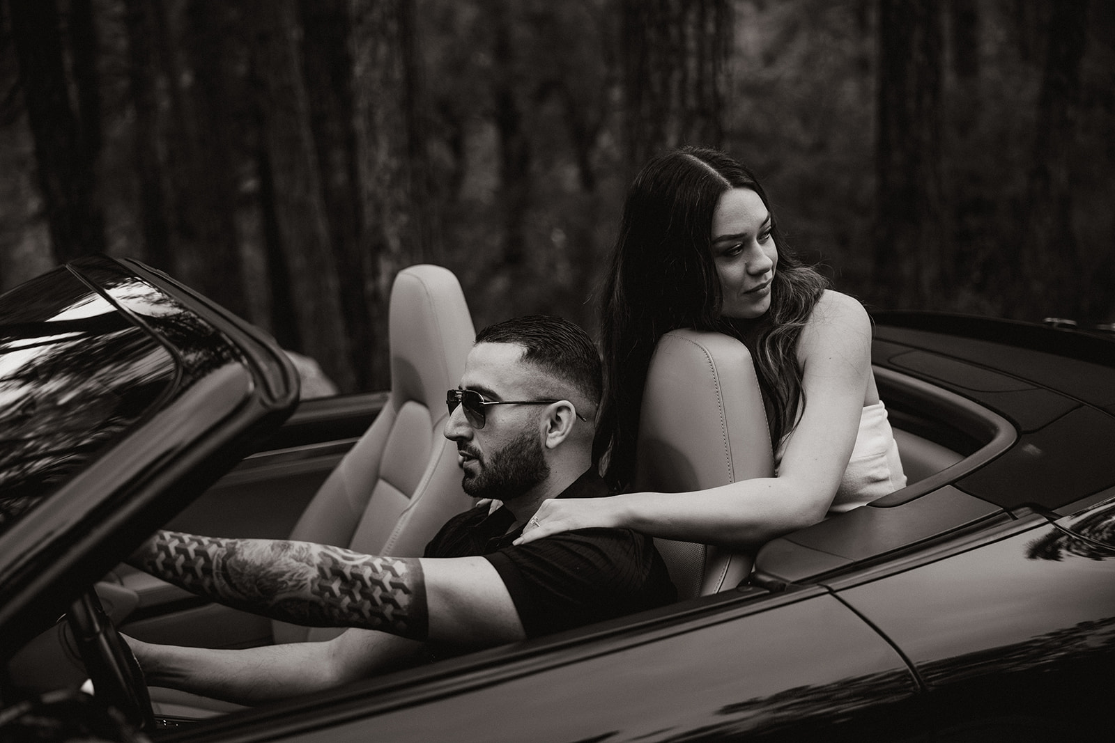 beautiful couple pose with their luxury car during their engagement photoshoot