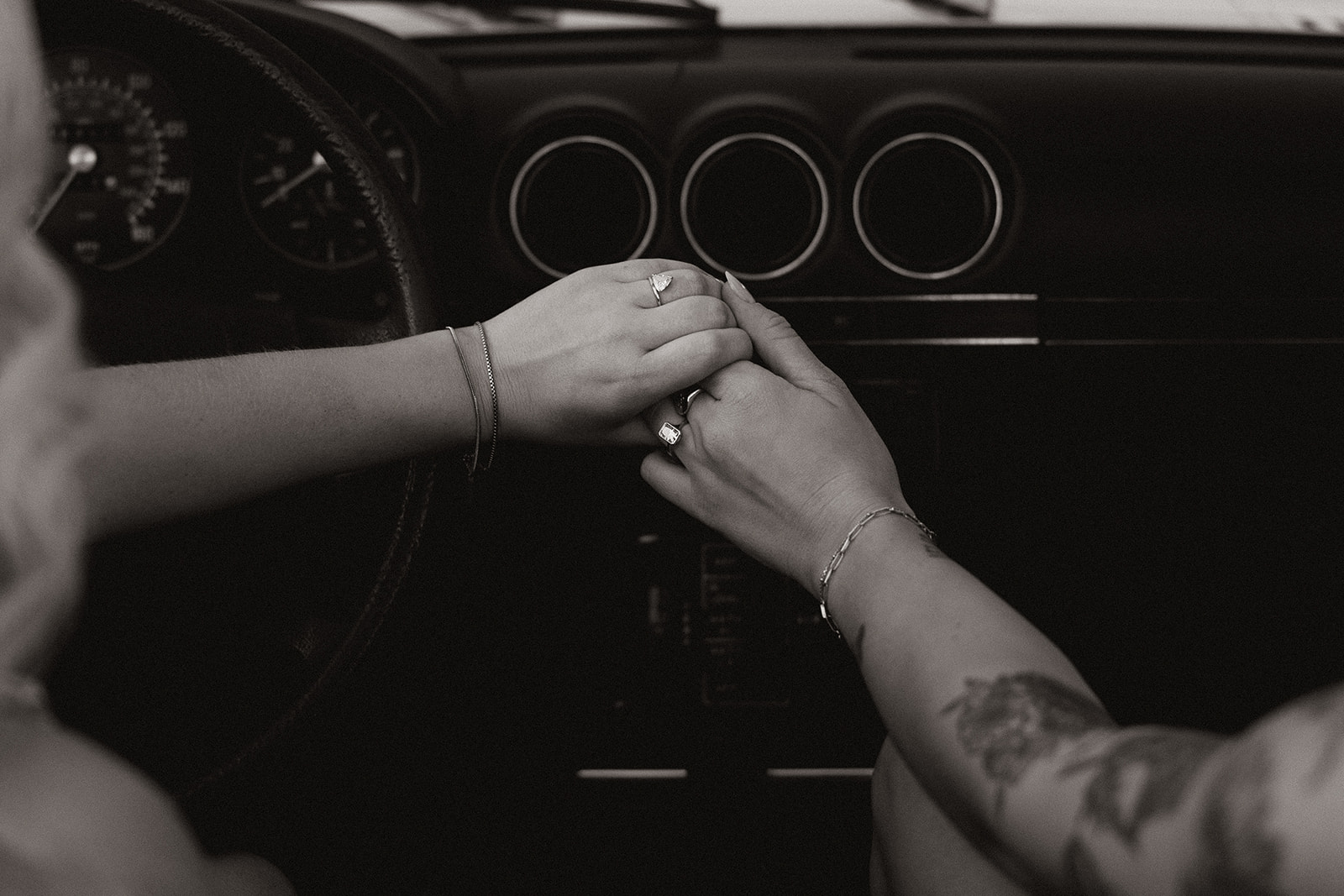 stunning couple pose with a vintage car during their engagement photos in the Arizona dessert