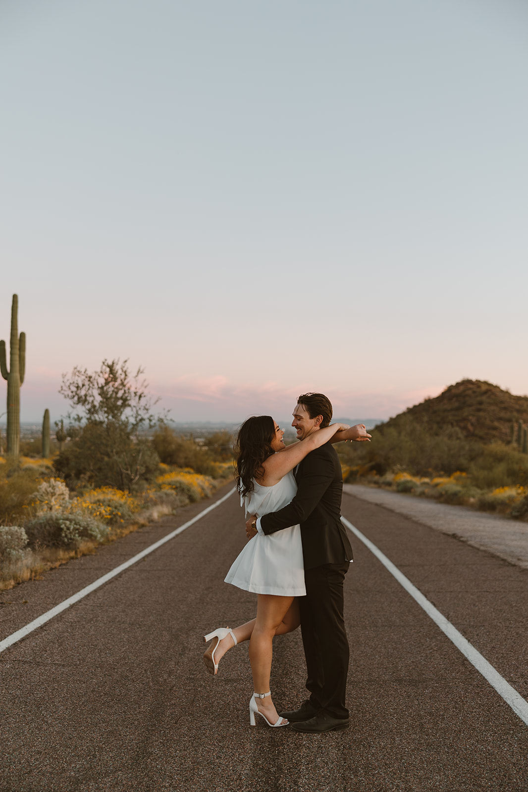 couple poses in the Arizona desert