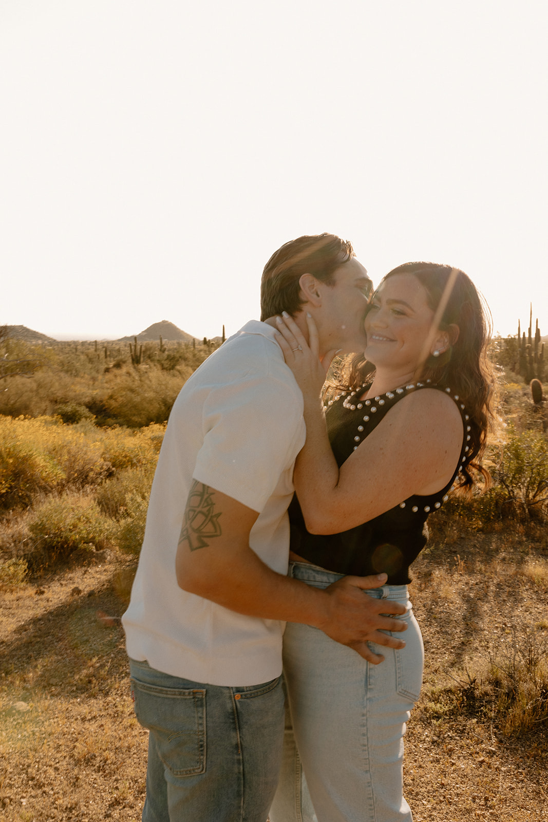 couple poses in the Arizona desert