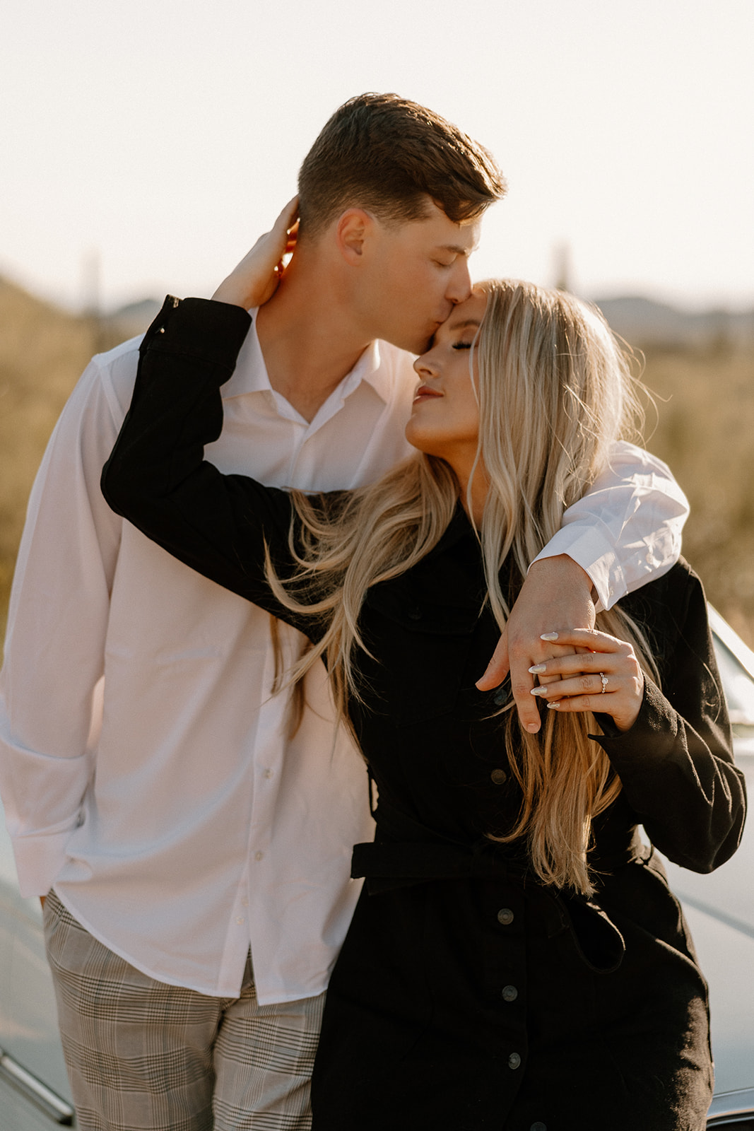 couple poses in the Arizona desert