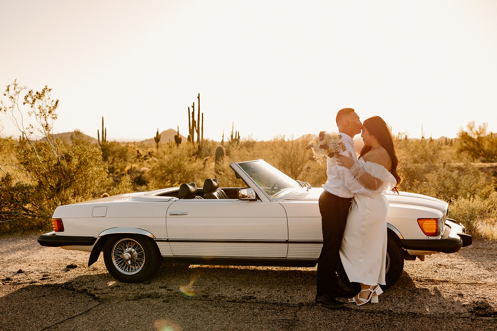 couple poses in the Arizona desert