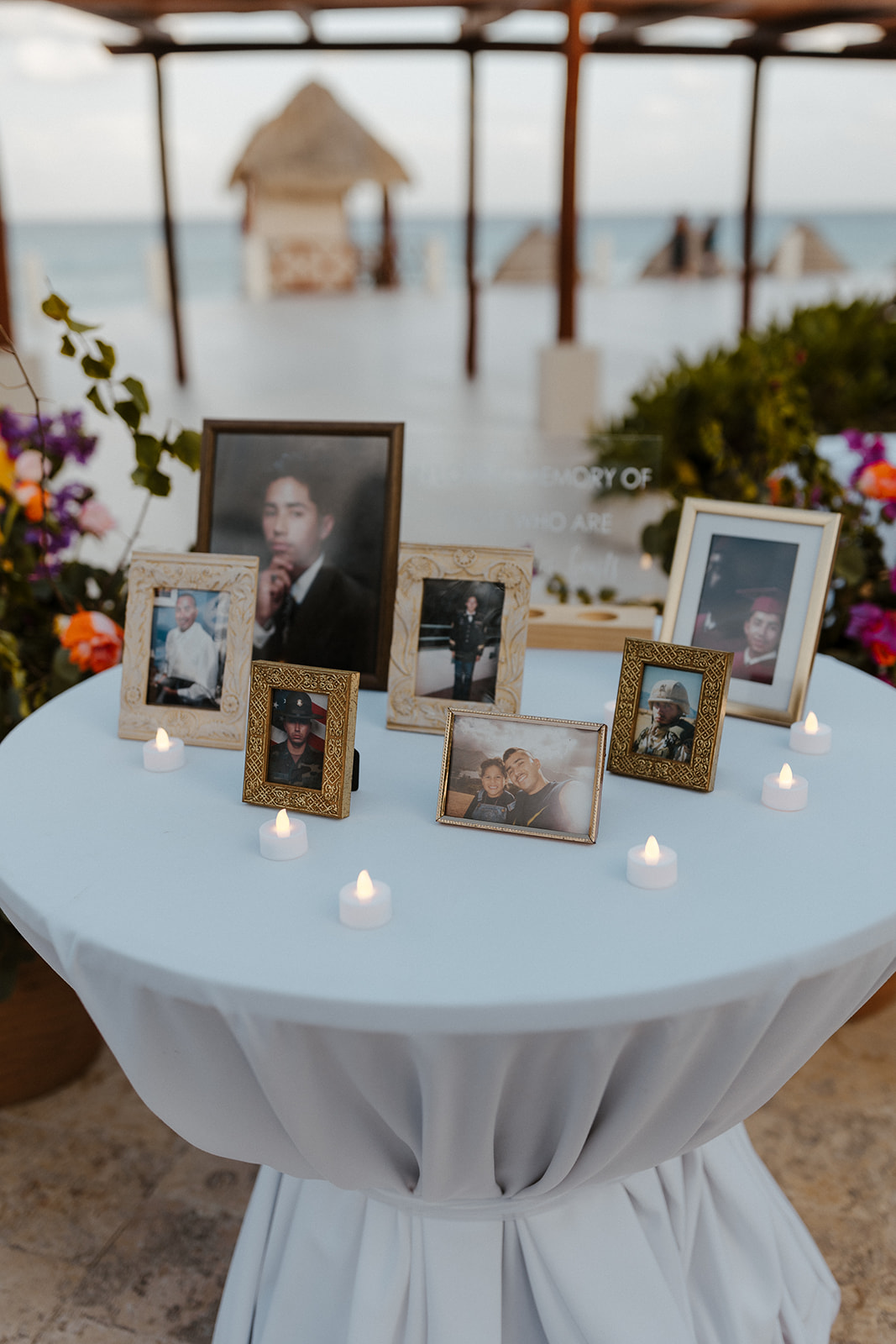 memory table with 7 photos surrounded by tea lights