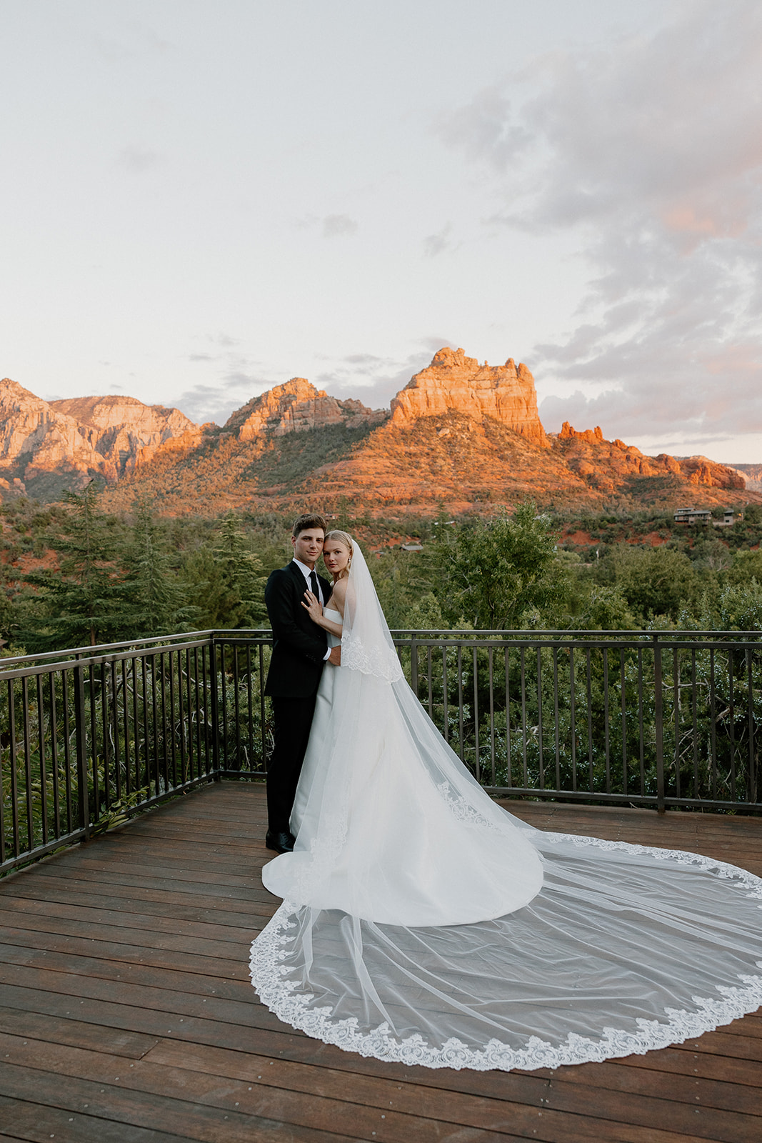 stunning bride and groom pose for a photo with the Arizona desert in the background