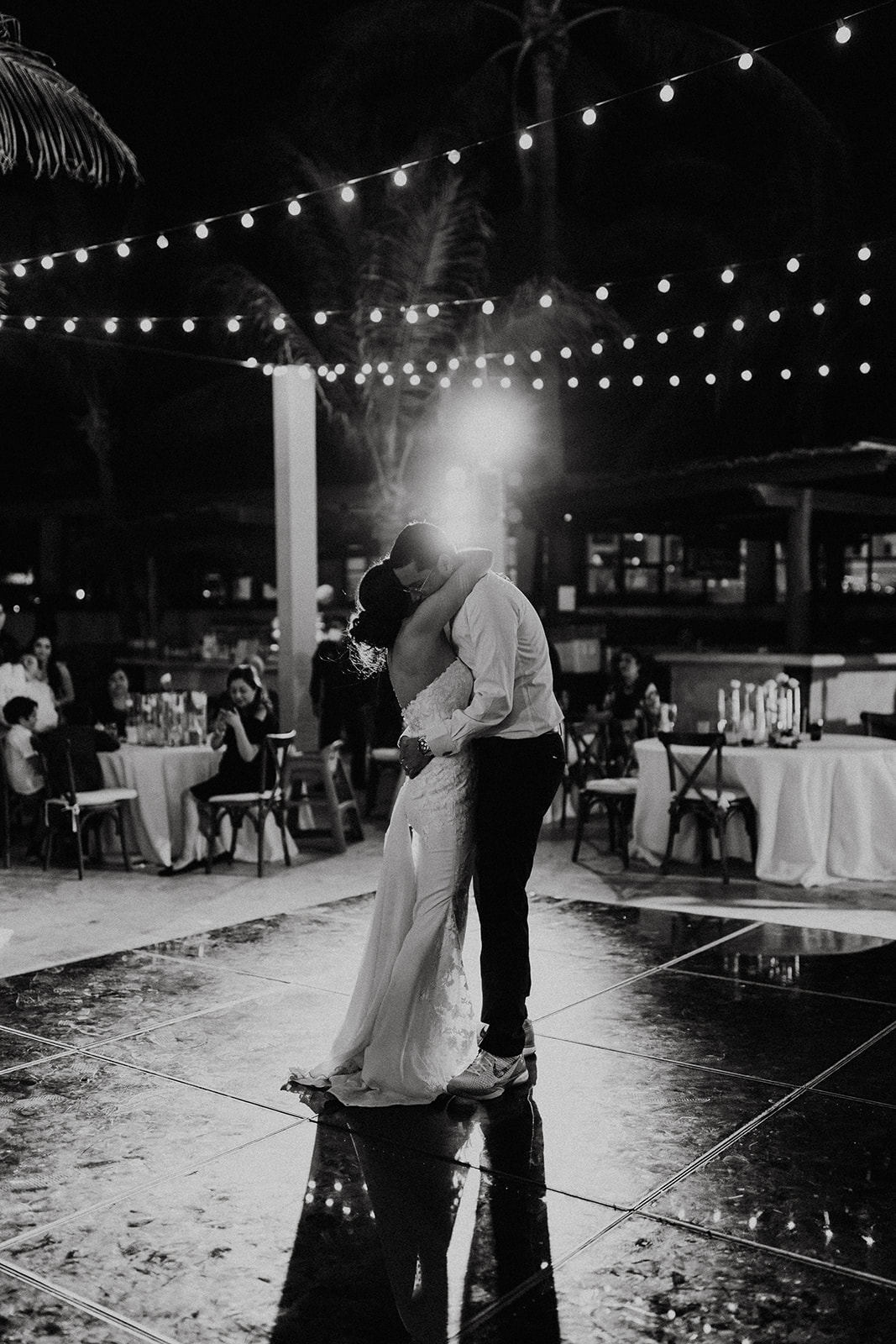 bride and groom share a dance during their destination wedding with sparklers