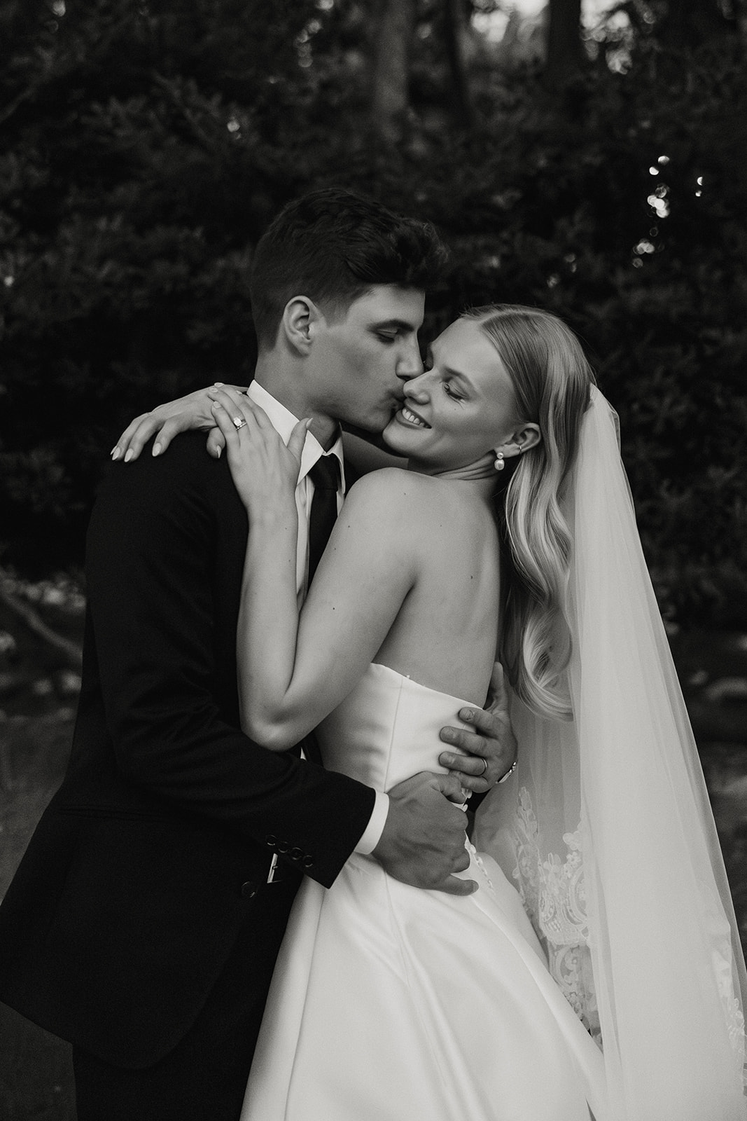 stunning bride and groom pose for a photo with the Arizona desert in the background