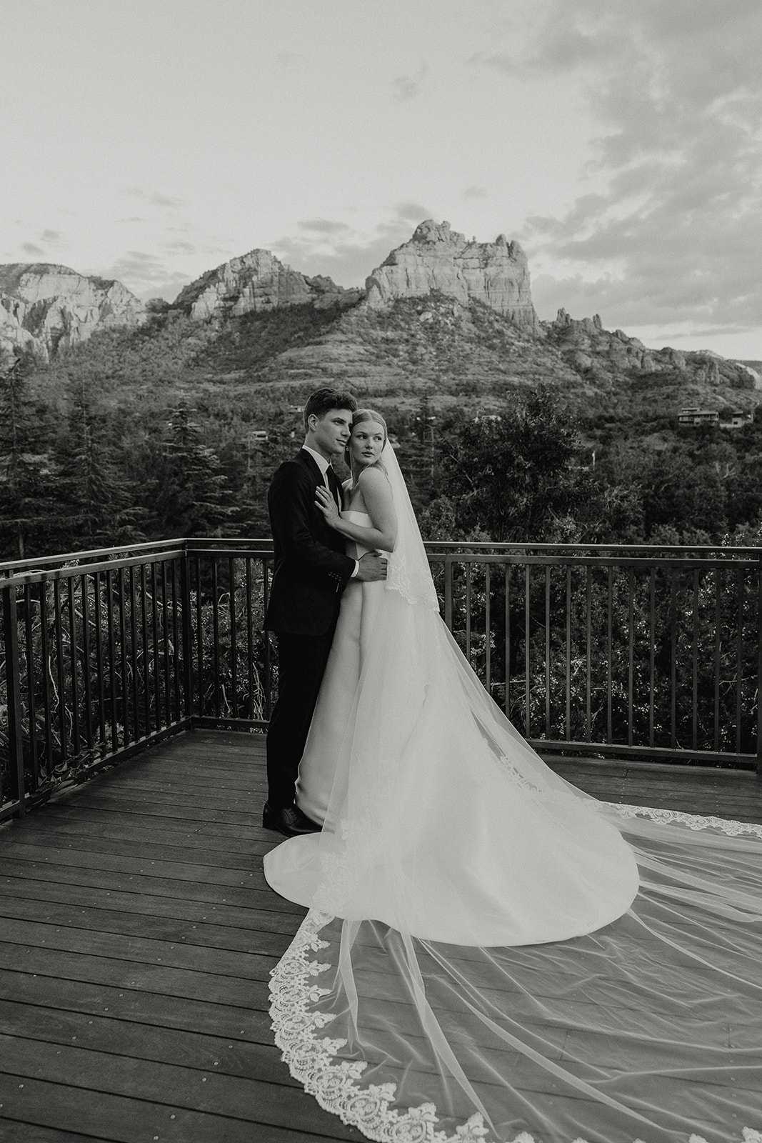 stunning bride and groom pose for a photo with the Arizona desert in the background