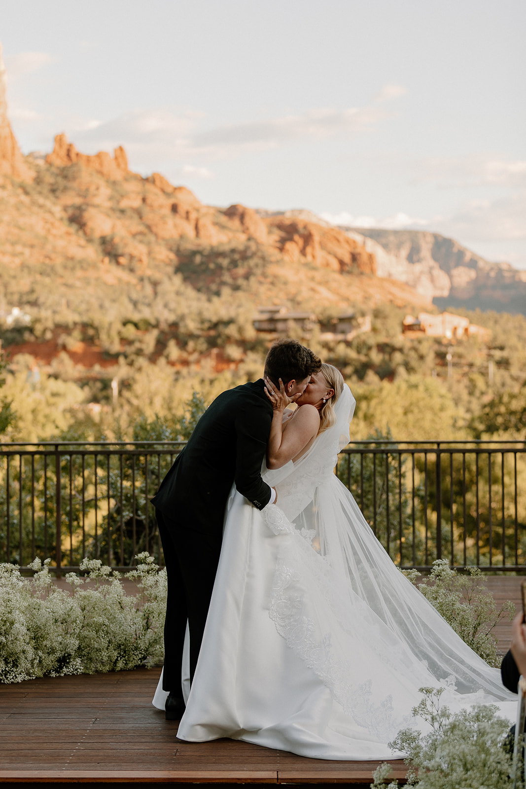 stunning bride and groom pose for a photo with the Arizona desert in the background