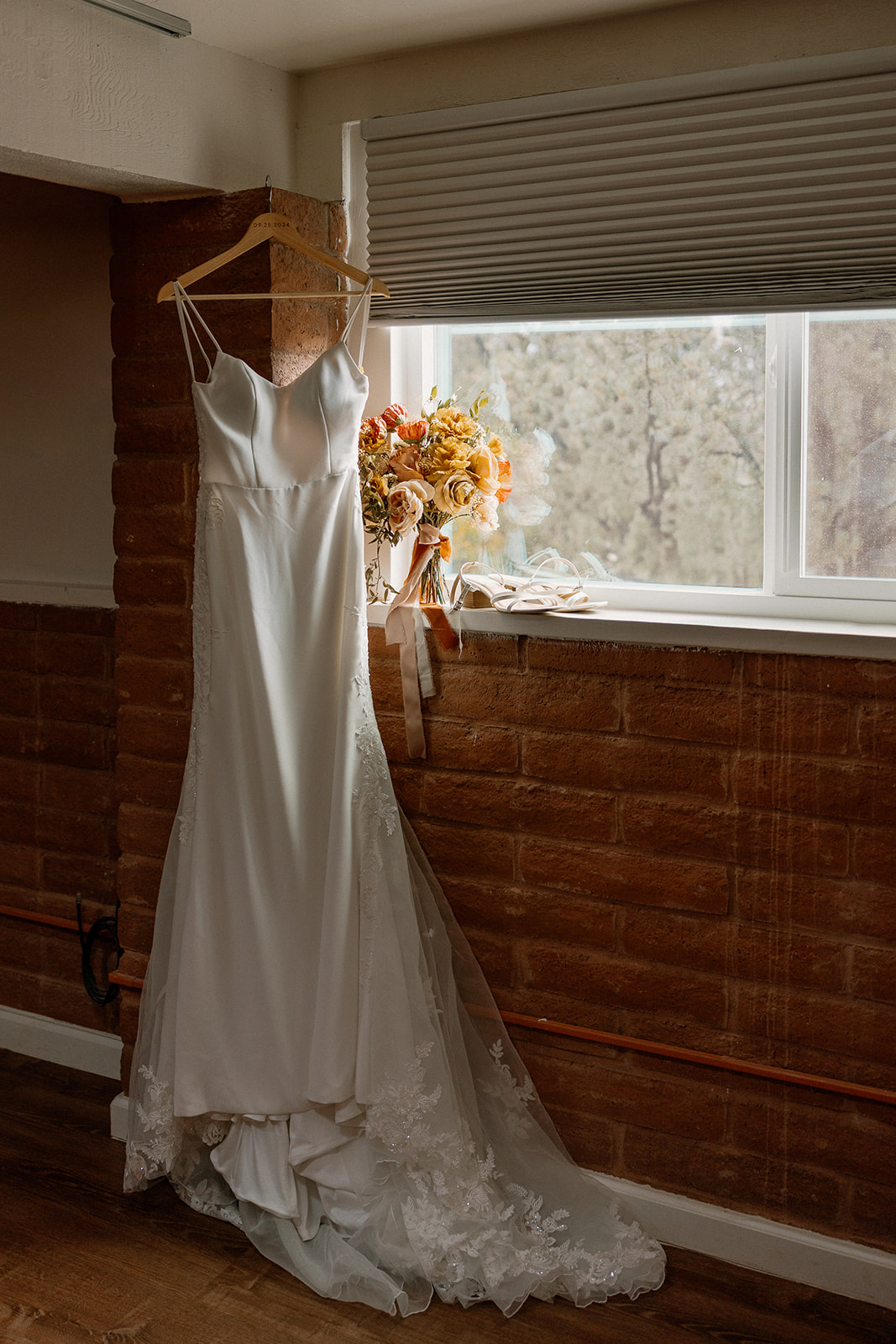 beautiful photo of brides wedding dress hanging before her Arizona wedding day