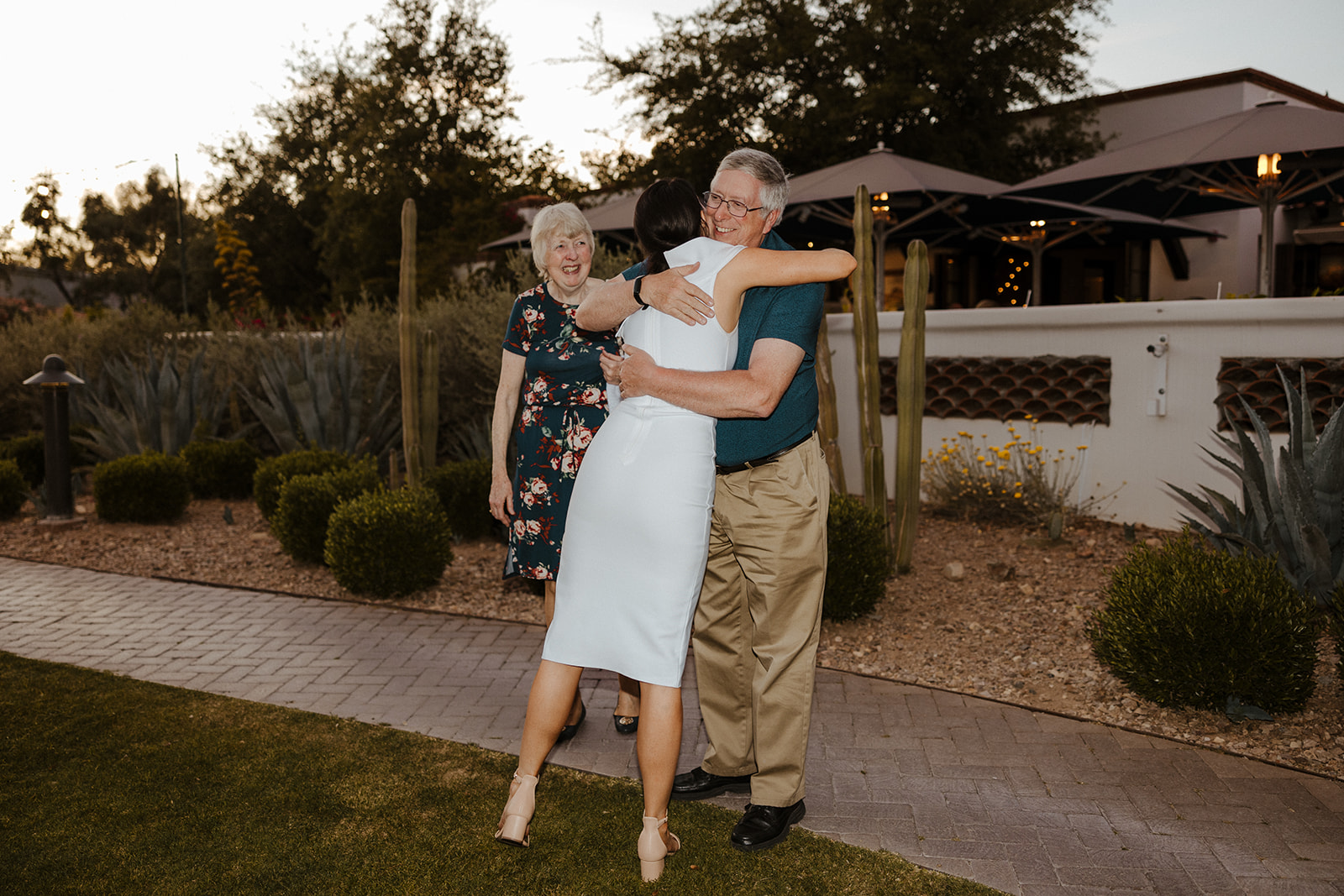 bride shares candid moments with guests during their rehearsal wedding reception