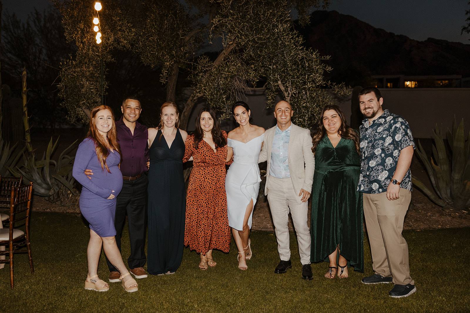 bride and groom pose with guests 