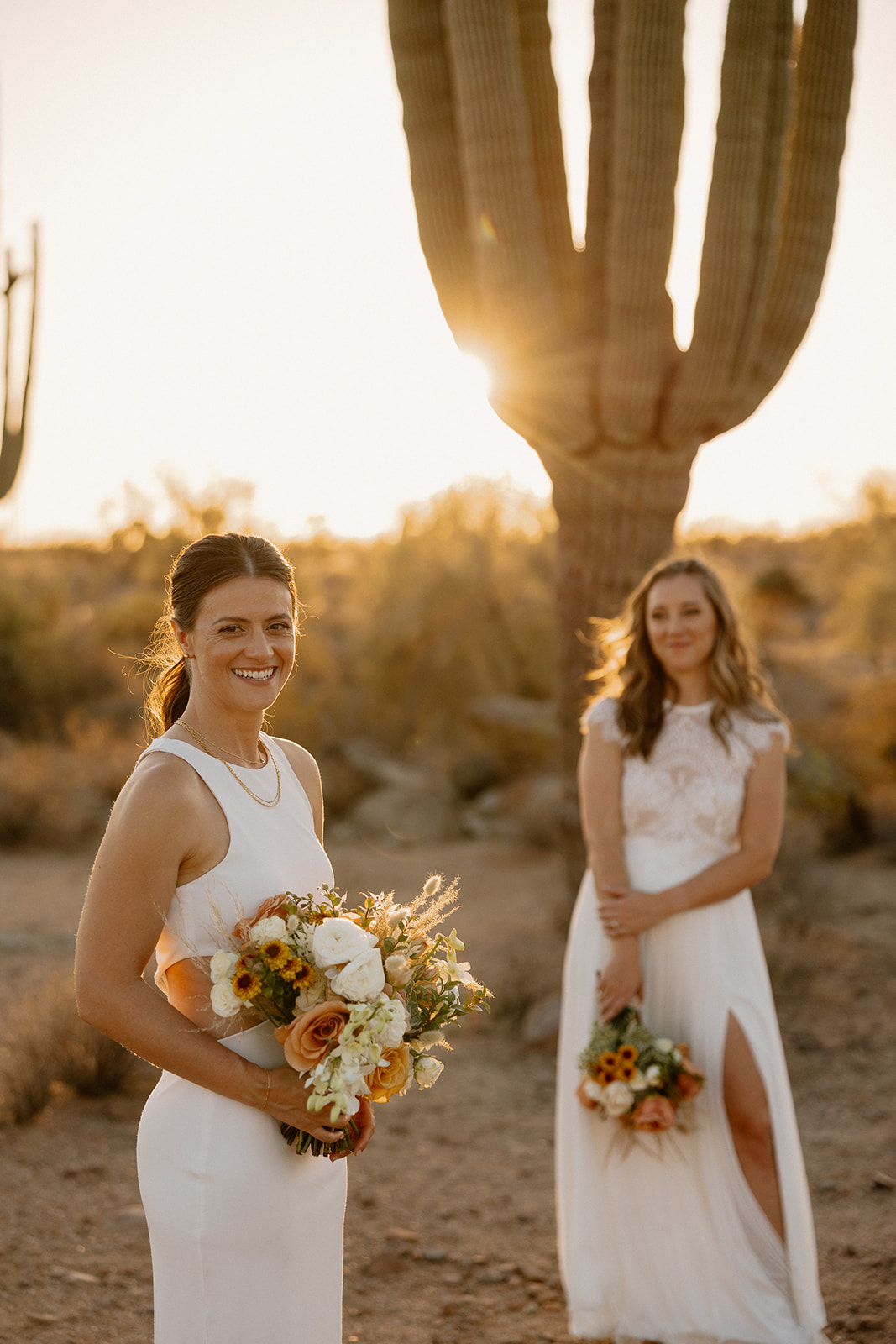 beautiful brides pose together in the Arizona desert after their Arizona wedding day