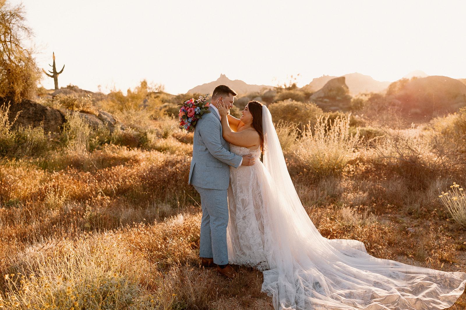 bride and groom pose together after getting married in arizona